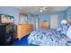 Blue-themed bedroom showcasing dresser, TV, and comfortable bedding at 19451 Gulf Blvd # 211, Indian Shores, FL 33785
