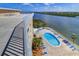 Aerial view of the community pool and deck area with lounge chairs at 19451 Gulf Blvd # 211, Indian Shores, FL 33785