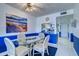 Bright dining area features a glass table, seating for four, and stylish decor at 19451 Gulf Blvd # 211, Indian Shores, FL 33785