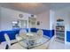 Light-filled dining area with glass table and seating, adjacent to kitchen at 19451 Gulf Blvd # 211, Indian Shores, FL 33785