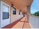 Hallway to unit with impact windows and exterior lighting at 19451 Gulf Blvd # 211, Indian Shores, FL 33785