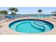 Community hot tub with lounge chairs and nearby pool at 19451 Gulf Blvd # 211, Indian Shores, FL 33785
