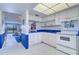 The kitchen features modern appliances, blue countertops and white cabinets at 19451 Gulf Blvd # 211, Indian Shores, FL 33785