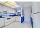 The bright kitchen has white appliances and blue countertops at 19451 Gulf Blvd # 211, Indian Shores, FL 33785