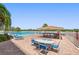 Community pool area featuring lounge chairs, dining tables, and a covered bar area at 19451 Gulf Blvd # 211, Indian Shores, FL 33785