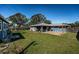 Beautiful backyard showcasing a covered patio, a blue shed, and a well-manicured lawn at 1965 Allard Dr, Clearwater, FL 33763