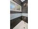 Close-up of bathroom showing updated shower features, a window, and neutral gray tiles at 1965 Allard Dr, Clearwater, FL 33763