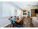 Eat-in kitchen with a custom wood and epoxy table, hardwood floors, and large windows at 1965 Allard Dr, Clearwater, FL 33763