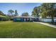 Charming one story home with a lush lawn, classic curb appeal and rocking chairs at 1965 Allard Dr, Clearwater, FL 33763