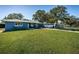 Lawn with blue house and long driveway, ideal for parking multiple vehicles, boats, or RVs at 1965 Allard Dr, Clearwater, FL 33763