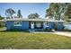 Charming one story home with a lush lawn, classic curb appeal and rocking chairs at 1965 Allard Dr, Clearwater, FL 33763