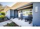Cozy front porch seating area with classic rocking chairs and a quaint accent table at 1965 Allard Dr, Clearwater, FL 33763