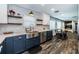 Well-lit kitchen with stainless steel appliances, white subway tile, and two-tone navy and white cabinets at 1965 Allard Dr, Clearwater, FL 33763