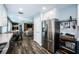 Open-concept kitchen with stainless steel appliances, dining area, and access to the living room at 1965 Allard Dr, Clearwater, FL 33763