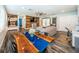 Open-concept living room features a wood accent wall, modern ceiling fan, and hardwood floors at 1965 Allard Dr, Clearwater, FL 33763