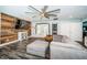 Open living room with hardwood floors, a rustic wood wall, and a modern ceiling fan at 1965 Allard Dr, Clearwater, FL 33763