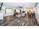 Open concept living room with eat in space, hardwood floors, and French doors to the exterior at 1965 Allard Dr, Clearwater, FL 33763