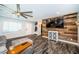 Living room featuring hardwood floors and a rustic wood accent wall with television at 1965 Allard Dr, Clearwater, FL 33763