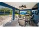 Covered patio featuring outdoor dining and seating area, overlooking the backyard and shed at 1965 Allard Dr, Clearwater, FL 33763