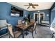 Inviting outdoor patio with dining area, TV, ceiling fan, and access to the backyard at 1965 Allard Dr, Clearwater, FL 33763