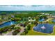 A birds eye view of a community with ponds, fountains, mature landscaping and sidewalks at 20305 Oak Key Ct, Tampa, FL 33647