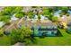 Aerial view of a townhome with a manicured lawn and a serene pond in a well-maintained community at 20305 Oak Key Ct, Tampa, FL 33647