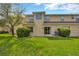 The private backyard features a green lawn, landscaping, and a patio with sliding glass doors at 20305 Oak Key Ct, Tampa, FL 33647