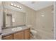 Bathroom featuring a large mirror, oak cabinets, and a shower and tub combination at 20305 Oak Key Ct, Tampa, FL 33647