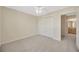 Neutral bedroom featuring gray carpet, a ceiling fan, and closet with sliding doors at 20305 Oak Key Ct, Tampa, FL 33647