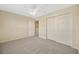 Bedroom with neutral walls, gray carpet, a ceiling fan, and closet with sliding doors at 20305 Oak Key Ct, Tampa, FL 33647