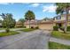 Exterior view showcasing the townhome's facade, attached garages, and green landscaping at 20305 Oak Key Ct, Tampa, FL 33647