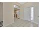 Open foyer with tile flooring leading to the kitchen and featuring a white front door at 20305 Oak Key Ct, Tampa, FL 33647