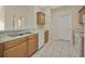 Open kitchen with tile floors featuring a stainless steel sink and white dishwasher at 20305 Oak Key Ct, Tampa, FL 33647