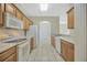 Bright kitchen featuring tile floors, white appliances and wood cabinets with white countertops at 20305 Oak Key Ct, Tampa, FL 33647