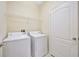 Laundry room featuring a washer, dryer, and wire shelving for storage at 20305 Oak Key Ct, Tampa, FL 33647
