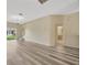Bright living room features wood-style flooring, neutral walls, and sliding glass doors at 20305 Oak Key Ct, Tampa, FL 33647
