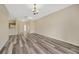 Open living room with vinyl flooring and a light fixture at 20305 Oak Key Ct, Tampa, FL 33647