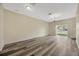 Bright living room features wood-style flooring, neutral walls, and sliding glass doors at 20305 Oak Key Ct, Tampa, FL 33647