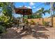 Backyard patio with pavers, a covered table and chairs, surrounded by tropical foliage at 230 32Nd N Ave, St Petersburg, FL 33704