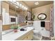 Clean and well-maintained bathroom featuring a large mirror, vanity, and a shower with modern fixtures at 230 32Nd N Ave, St Petersburg, FL 33704