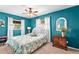 Bright bedroom featuring a ceiling fan, windows, and tropical-themed bedding at 230 32Nd N Ave, St Petersburg, FL 33704