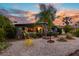 Exterior of home featuring a well-manicured yard and a palm tree at sunset at 230 32Nd N Ave, St Petersburg, FL 33704