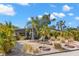 Inviting home featuring a unique, landscaped front yard with palms, stone accents, and a colorful exterior at 230 32Nd N Ave, St Petersburg, FL 33704