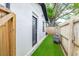 Cozy backyard area with artificial turf, seating, and a privacy fence at 2511 W Braddock St, Tampa, FL 33607