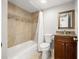 Clean bathroom with tiled walls, granite vanity, and shower-tub combo at 2511 W Braddock St, Tampa, FL 33607