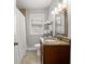 Bathroom featuring a vanity with granite countertop, window, and tiled shower with curtain at 2511 W Braddock St, Tampa, FL 33607