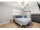 Clean bedroom with ceiling fan, clothing rack and dresser storage at 2511 W Braddock St, Tampa, FL 33607