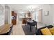 The dining room has neutral gray walls and curtains, with a chandelier overhead and tiled floors at 2511 W Braddock St, Tampa, FL 33607