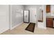 Well-lit entryway featuring a storage cabinet, bench, and tiled flooring at 2511 W Braddock St, Tampa, FL 33607