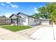 This home boasts a long driveway leading to a detached garage, surrounded by lush greenery at 2511 W Braddock St, Tampa, FL 33607